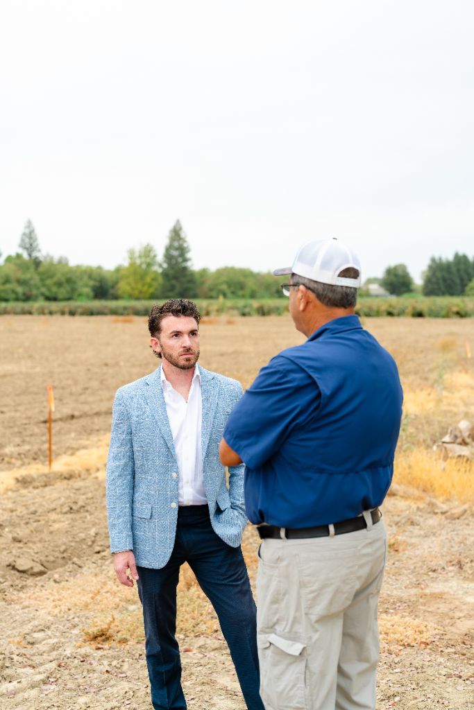 Adviser and farm family walking through a Central Valley field